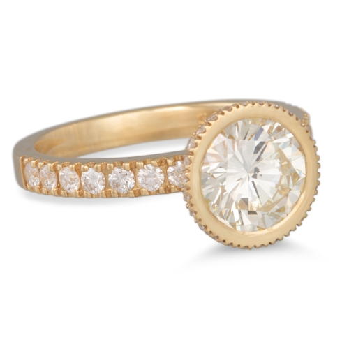 219 - A DIAMOND SOLITAIRE RING, the brilliant cut diamond bezel, diamond set shoulders, 18ct yellow gold m... 