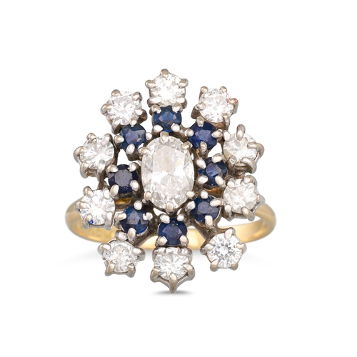 46 - A SAPPHIRE AND DIAMOND CLUSTER RING, the central oval cut diamond to sapphire surround to outer diam... 