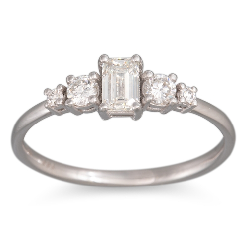 276 - A DIAMOND FIVE STONE RING, the emerald cut diamond flanked by graduated round brilliant cut diamonds... 