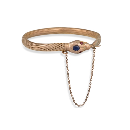 29 - AN ANTIQUE 9CT GOLD BRACELET, modelled as a snake, set with sapphire and rubies