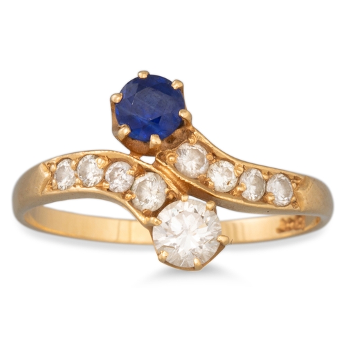 17 - A SAPPHIRE AND DIAMOND CROSS-OVER RING, mounted in 18ct gold, size M