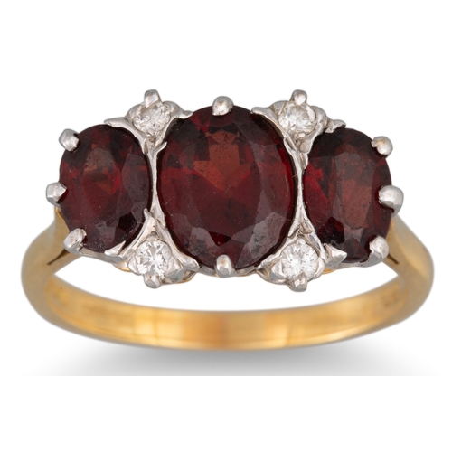 20 - A GARNET AND DIAMOND RING, mounted in 18ct gold, size T