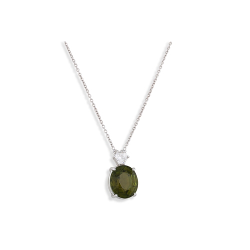 79 - A DIAMOND AND GREEN TOURMALINE PENDANT, the oval tourmaline to a kite shaped diamond set bezel in 18... 