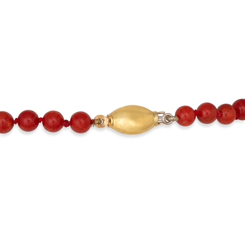 143 - A CORAL BEADED NECKLACE, to an 18ct yellow gold clasp