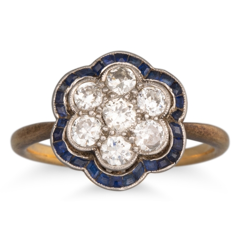 25 - AN EDWARDIAN SAPPHIRE AND DIAMOND RING, the old cut diamond to sapphire surround, mounted in 18ct ye... 