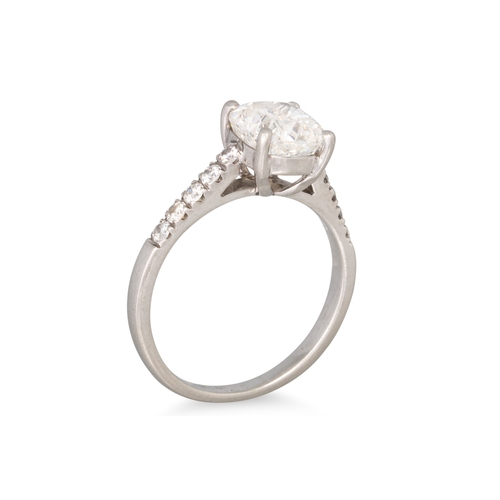 276 - A DIAMOND SOLITAIRE RING, the cushion cut diamond to diamond shoulders, mounted in platinum. Togethe... 