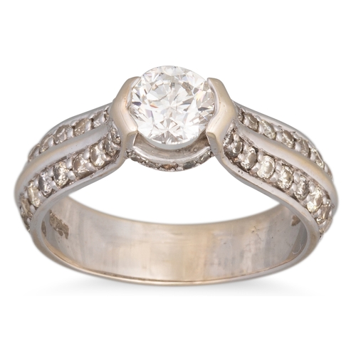 159 - A DIAMOND SOLITAIRE RING, the central round brilliant cut diamond to diamond shoulders, mounted in g... 