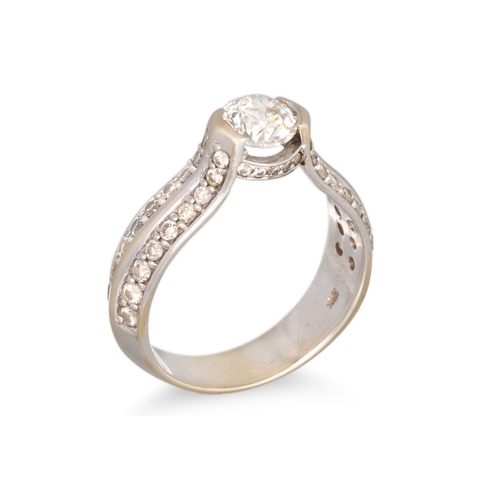 159 - A DIAMOND SOLITAIRE RING, the central round brilliant cut diamond to diamond shoulders, mounted in g... 