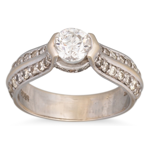 159 - A DIAMOND SOLITAIRE RING, the central round brilliant cut diamond to diamond shoulders, mounted in g... 