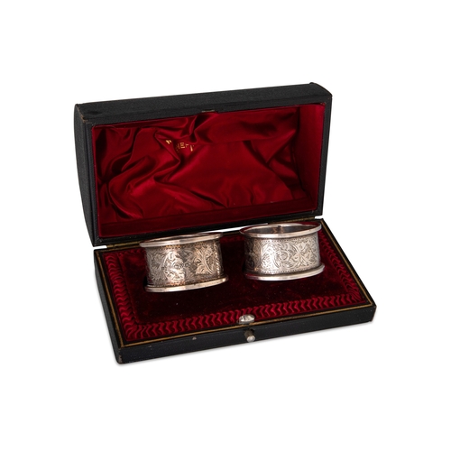 472 - A PAIR OF CASED SILVER NAPKIN RINGS, Chester 1908, S Black Snr., together with a cased silver spoon ... 