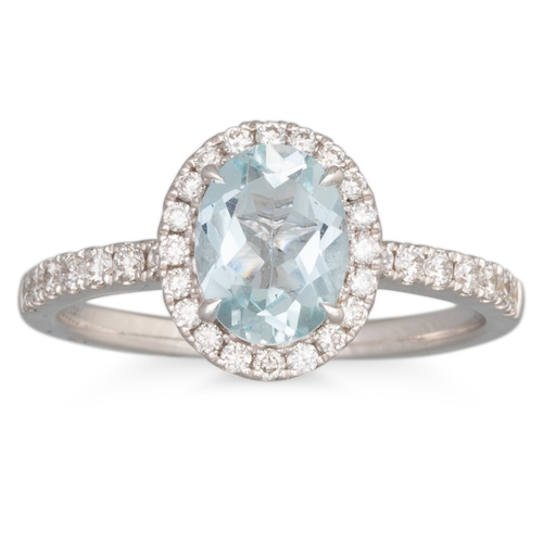 260 - AN AQUAMARINE AND DIAMOND CLUSTER RING, the oval aquamarine to diamond surround and diamond shoulder... 