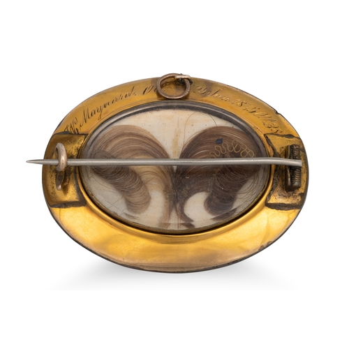 50 - A VICTORIAN GOLD AND ENAMEL MEMORIAL BROOCH, set with sardonyx to centre, glazed locket compartment ... 