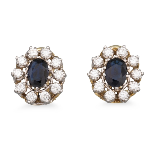 117 - A PAIR OF SAPPHIRE AND DIAMOND CLUSTER EARRINGS, the oval sapphire to diamond surround, mounted in 1... 