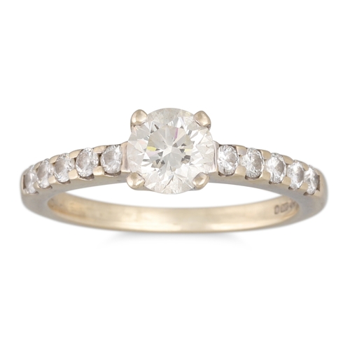 137 - A DIAMOND SOLITAIRE RING, the round brilliant cut diamond to diamond shoulders, mounted in 18ct whit... 