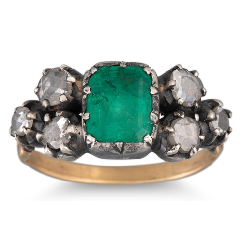 138 - A GEORGIAN EMERALD AND DIAMOND RING, the trap cut emerald to rose cut diamond shoulders, closed back... 