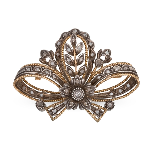 150 - A DIAMOND SET BROOCH, of scrolled form, mounted in gold & silver