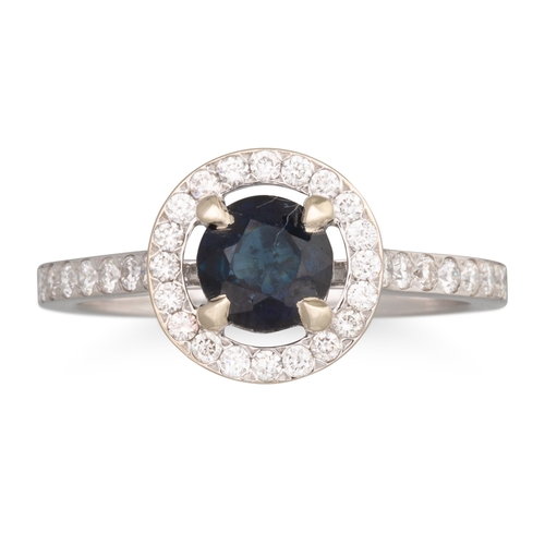 186 - A DIAMOND AND SAPPHIRE CLUSTER RING, the circular sapphire to brilliant cut surround and shoulders, ... 