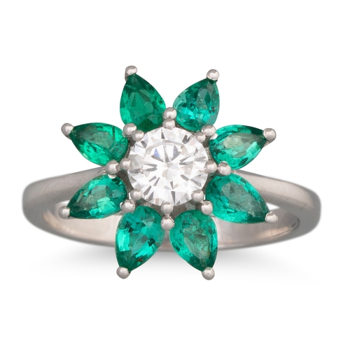 189 - AN EMERALD AND DIAMOND CLUSTER RING, star shaped, mounted in 18ct white gold. Estimated: weight of d... 