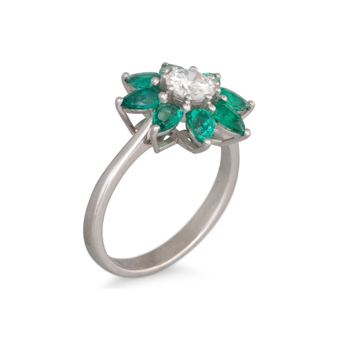 189 - AN EMERALD AND DIAMOND CLUSTER RING, star shaped, mounted in 18ct white gold. Estimated: weight of d... 