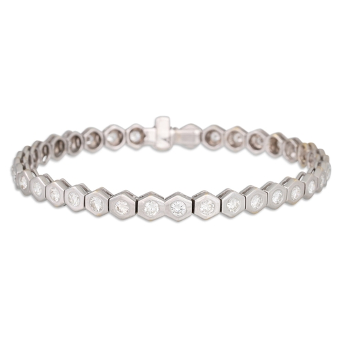 201 - A DIAMOND LINE BRACELET, the brilliant cut diamonds to hexagonal shaped collet mounts, in 18ct. whit... 