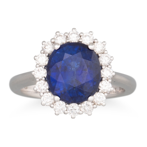 234 - A SAPPHIRE AND DIAMOND CLUSTER RING, the oval sapphire to brilliant cut diamond surround, mounted in... 