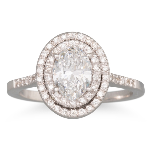 241 - A DIAMOND 'HALO' CLUSTER RING, the oval centre stone to two rowed diamond surround and shoulders, mo... 