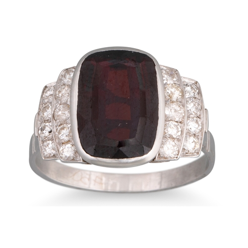 242 - A GARNET AND DIAMOND RING, the cushion cut garnet to diamond shoulders, in white gold, size O
... 