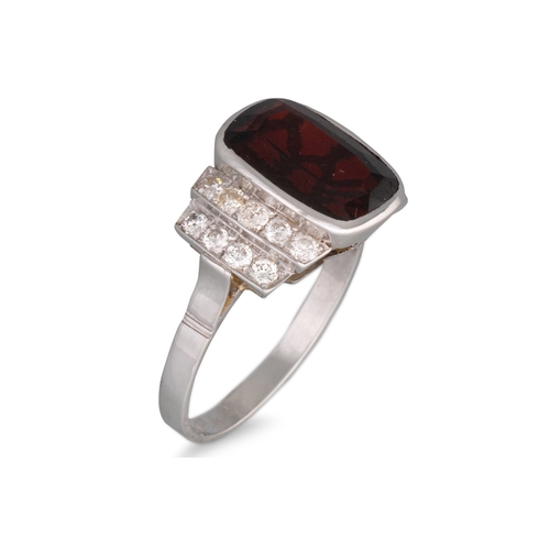 242 - A GARNET AND DIAMOND RING, the cushion cut garnet to diamond shoulders, in white gold, size O
... 