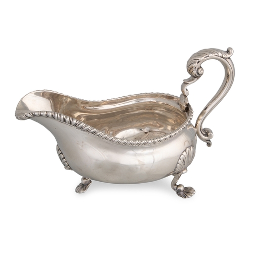 399 - A GEORGE III SILVER HELMET SHAPED SAUCE BOAT, with egg and dart border on three shell feet, London h... 