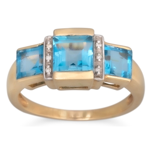 63 - A BLUE TOPAZ RING, the three square topaz stones to diamond detail, mounted in 9ct yellow gold, size... 