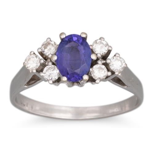 74 - A TANZANITE AND DIAMOND RING, the oval tanzanite to diamond trio shoulders, mounted in 14ct white go... 