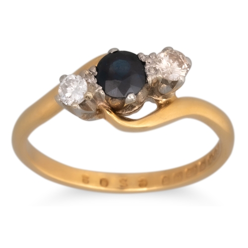 79 - A VINTAGE THREE STONE DIAMOND AND SAPPHIRE RING, the circular stones in cross-over 18ct yellow gold ... 