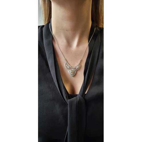 144 - A DIAMOND NECKLACE, the central shaped open work diamond set plaque to back chain, in white gold. Es... 