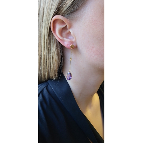 192 - A PAIR OF AMETHYST DROP EARRINGS, the oval amethysts suspended from 18ct chain drops