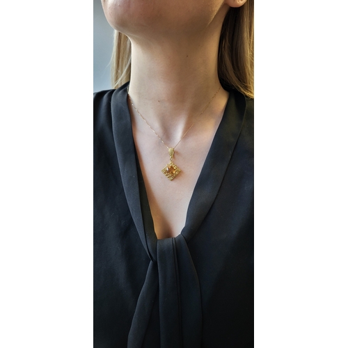 198 - A CITRINE PENDANT, to an 18ct yellow gold wire work mount, on an 18ct gold chain