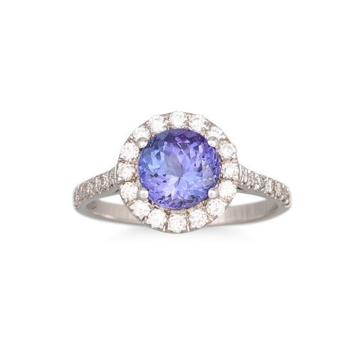 141 - A TANZANITE AND DIAMOND CLUSTER RING, of circular form to diamond shoulders, mounted in 18ct white g... 