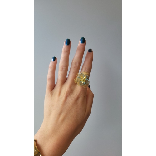 142 - A FLORAL DESIGN TOPAZ AND GOLD RING, mounted in yellow gold, 2cm width, size M... 