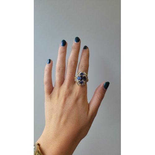 173 - A VINTAGE SAPPHIRE AND DIAMOND CLUSTER RING, the central sapphire cluster to a pavé diamond set surr... 