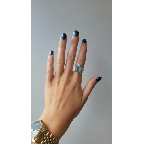 144 - AN AQUAMARINE AND DIAMOND RING, the large oval aquamarine to diamond shoulders, mounted in 18ct whit... 