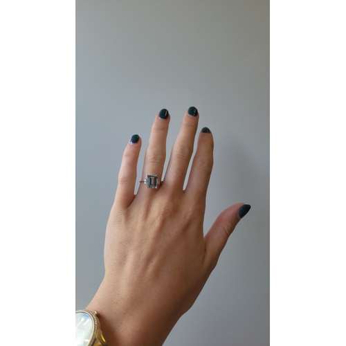 145 - AN AQUAMARINE AND DIAMOND RING, the rectangular aquamarine to diamond shoulders, mounted in 18ct whi... 