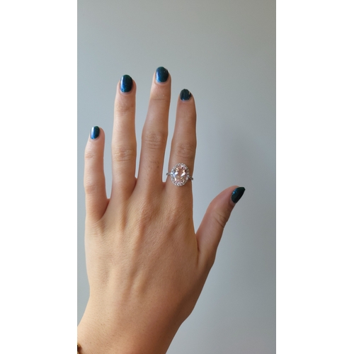146 - A MORGANITE AND DIAMOND RING, oval stone diamond surround and shoulders, mounted in 18ct white gold.... 
