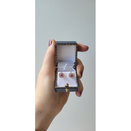 20 - A PAIR OF RUBY AND DIAMOND CLUSTER EARRINGS, the round rubies to diamond surrounds, mounted in 9ct y... 