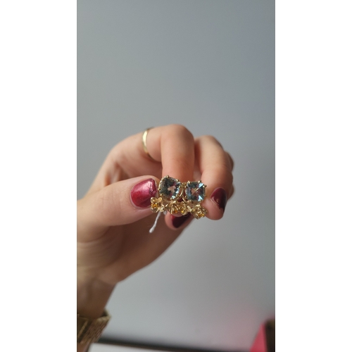 177 - A PAIR OF AQUAMARINE AND ORANGE SAPPHIRE EARRINGS, of naturalistic form, mounted in 14ct yellow gold... 