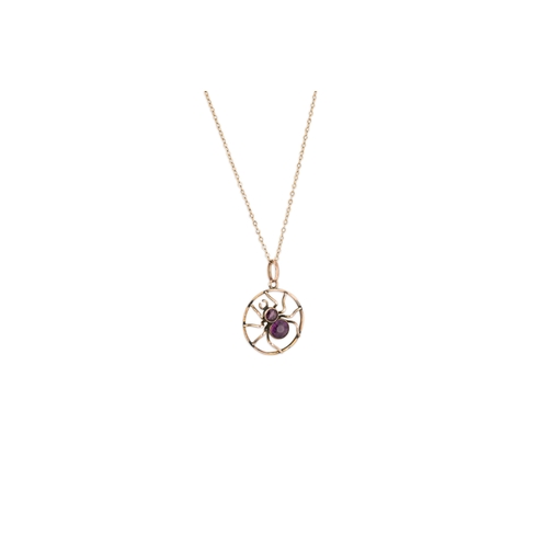 395 - AN ANTIQUE INSECT PENDANT, modelled as a spider, set with amethyst, stamped 9ct on a 9ct gold chain