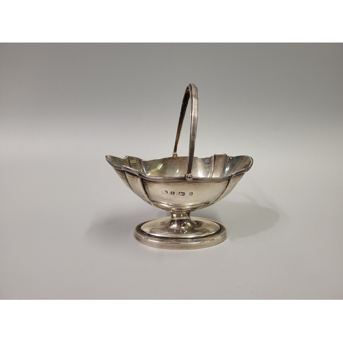 526 - AN ATTRACTIVE ANTIQUE ENGLISH STERLING SILVER (.925) SWING HANDLED HELMET SHAPED BON BON DISH, over ... 