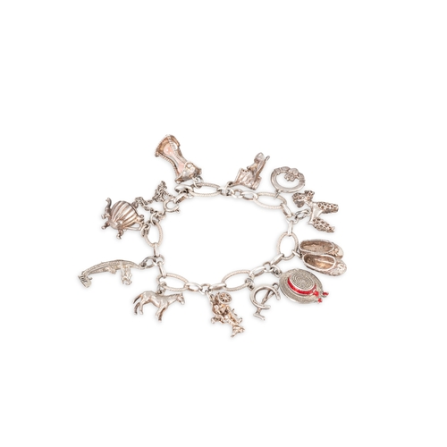 1 - TWO VINTAGE SILVER CHARM BRACELETS, various charms, mostly silver, 79 g. gross weight