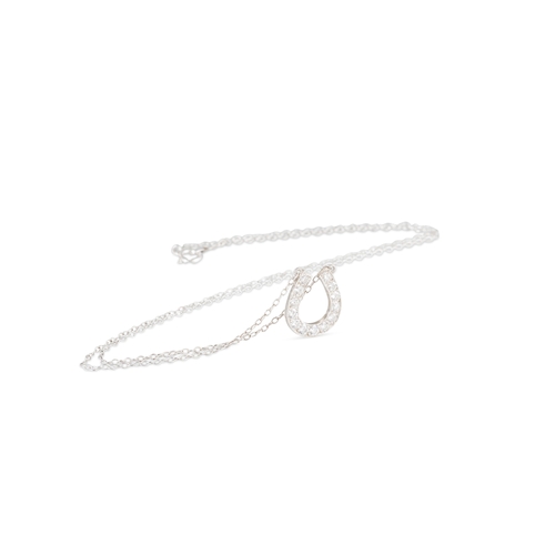 21 - A DIAMOND SET HORSESHOE PENDANT, the round cut diamonds mounted in silver set to a silver chain. Len... 