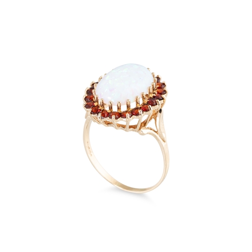 28 - A SYNTHETIC OPAL AND GARNET SET CLUSTER RING, the central synthetic opal to garnet set surround, mou... 