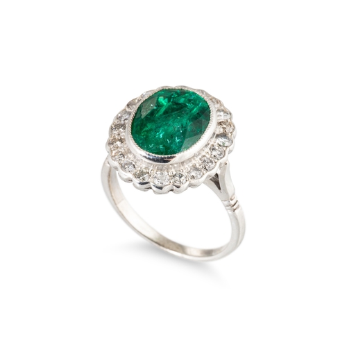 39 - AN EMERALD AND DIAMOND SET CLUSTER RING, the central oval emerald to diamond set surround, mounted i... 