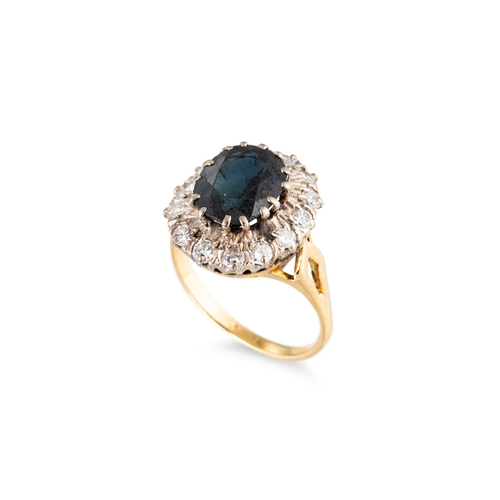 44 - A SAPPHIRE AND DIAMOND CLUSTER RING, the central oval sapphire to diamond set surround, stamped 18ct... 